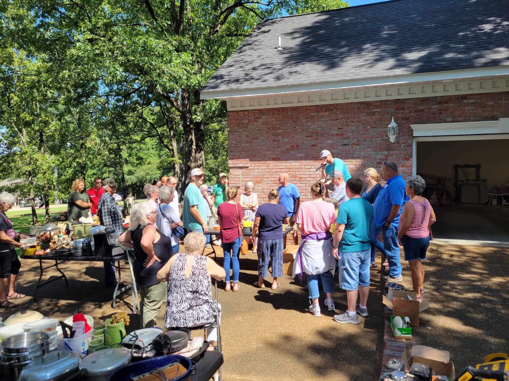 Bidders gathered at an outdoor estate auction